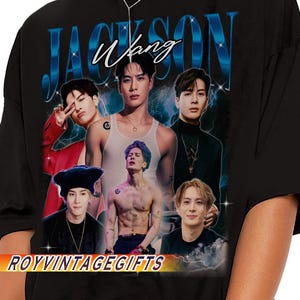 May include: Black t-shirt featuring a collage of images of Jackson Wang, with the name "Jackson Wang" in blue and white text. The shirt also has the text "ROYVINTAGEGIFTS" in a banner at the bottom.