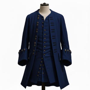 May include: A navy blue historical coat and vest set. The coat features multiple rows of gold-colored buttons, a mandarin collar, and decorative cuffs. The vest has a similar button design. The outfit is displayed on a mannequin against a white background.