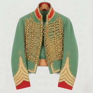 May include: A green military-style jacket with gold rope detailing and gold button accents. The jacket has red trim on the collar and cuffs. The jacket is hanging on a wooden hanger.