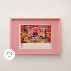 May include: A framed abstract art print in a pink frame. The artwork features a colorful, stylized design with figures, animals, and geometric shapes in red, yellow, blue, and black. The print is labeled "Premium Gallery Quality Print 240gsm".