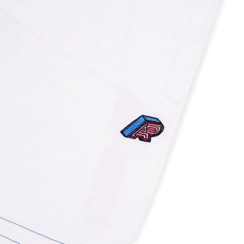 May include: White garment with a blue and red embroidered logo. The logo features the letters "AP" in a 3D design. The garment has visible stitching and a blue accent line.