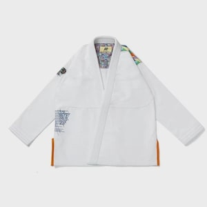 May include: White martial arts gi with colorful accents on the shoulder and collar. The gi features a geometric design on the sleeve and orange trim at the bottom. The gi is designed for martial arts training and competition.