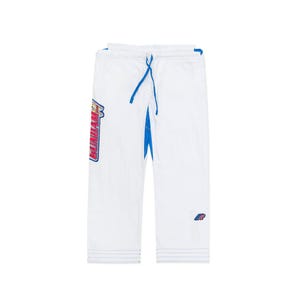 May include: White martial arts trousers with blue detailing and a drawstring. The trousers feature a large graphic on the left leg with the word "GUNDAM" in red, blue, and yellow. A small logo is on the right leg.