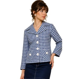 May include: A blue and white gingham blazer with a notched collar, long sleeves, and white buttons. The blazer has two front pockets with white button details. The garment is worn with a dark blue denim skirt.
