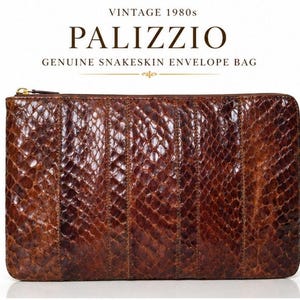 May include: A brown snakeskin envelope bag with a rectangular shape and a gold-tone zip closure. The text above the bag reads: VINTAGE 1980s PALIZZIO GENUINE SNAKESKIN ENVELOPE BAG. The bag features a textured scale pattern across the entire surface.