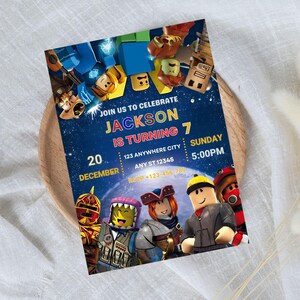 May include: A birthday party invitation featuring a space-themed design with cartoon characters. The invitation reads "Join us to celebrate Jackson is turning 7" with the date, time, and location details. The invitation is on a wooden tray.