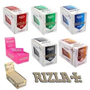 May include: A selection of Rizla rolling paper boxes in different colours, such as red, green, blue, silver, and orange. The boxes display the Rizla logo and product details. Also shown is a pink box of Aisia rolling papers and a display box of Rizla papers.
