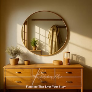 May include: A wooden chest of drawers with six drawers, a round mirror, and decorative items. A coat hangs in the mirror's reflection. The text "Furniture That Lives Your Story" is at the bottom.