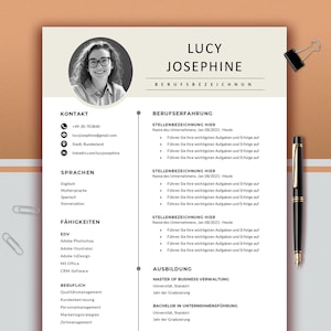 May include: A professional resume template with the name "LUCY JOSEPHINE" at the top. The resume includes sections for contact details, skills, and work history. A black pen and a binder clip are on the background.