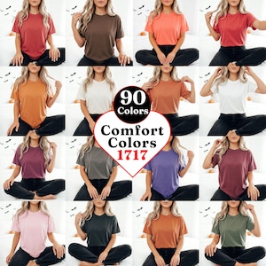 Può includere: Una collezione di t-shirt Comfort Colors 1717 in 90 colori diversi. Ogni maglietta a maniche corte presenta un girocollo e un design a tinta unita. La grafica centrale mostra il testo 90 Colors Comfort Colors 1717.
