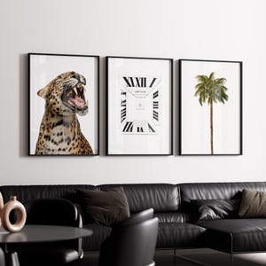 May include: Three framed art prints. The left print features a leopard with its mouth open. The center print has a clock design with the text "GIRL CLUB". The right print shows a palm tree. All prints have black frames.