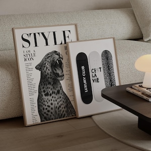 May include: Two framed art prints. One features a black and white image of a roaring leopard with the word "STYLE" at the top. The other has three skateboard decks, one black with "LUXURY CLUB", one white with "CEST LA VIE", and one with a leopard print.