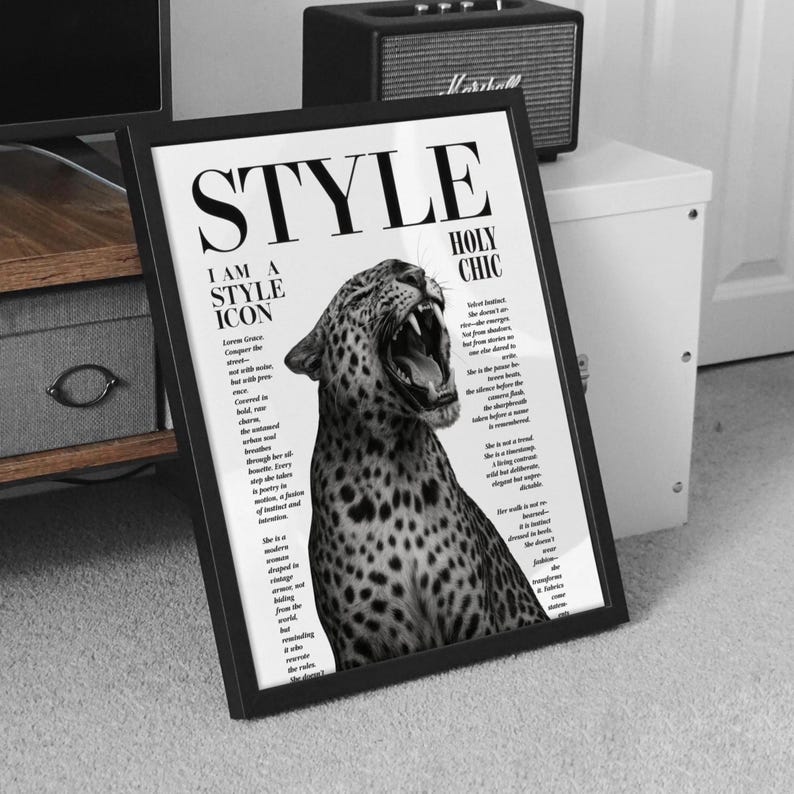 May include: Monochrome framed print featuring a roaring leopard and the word "STYLE". Text includes "I AM A STYLE ICON" and "HOLY CHIC". The print is propped against a white cabinet, with a small speaker visible.