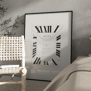 May include: A framed art print with a white background and a geometric design incorporating Roman numerals. The words "GIRL CLUB" are centered. The print is displayed in a room with a woven chair and a bed.