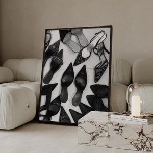 May include: Black and white framed art print featuring an assortment of women's shoes. The shoes include heels, flats, and sandals, with various designs and textures. The artwork is displayed on a white background.