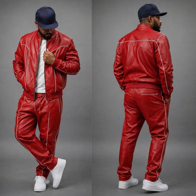 May include: A red leather tracksuit with white piping. The jacket has a zip closure and the pants have a drawstring waist. The outfit is worn with a white t-shirt and white sneakers. The person is wearing a navy blue baseball cap.