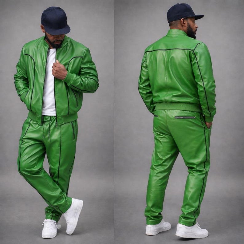 May include: A two-piece green leather tracksuit with black trim. The jacket is a bomber style, and the pants are straight-legged. The outfit is paired with a white t-shirt and white sneakers. A navy blue baseball cap completes the look.