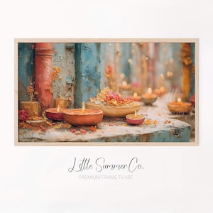 May include: A framed print featuring a warm, inviting scene with lit candles in small, round bowls. The artwork has a textured, painterly style with a color palette of orange, pink, and blue. The text "Little Summer Co." is at the bottom.
