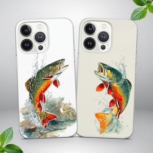 May include: Two phone cases featuring a watercolor illustration of a jumping fish. The fish has red, orange, green, and brown scales, with water droplets around it. One case has a white background, the other a cream background.