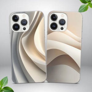 May include: Two phone cases with abstract wave designs. One case features a gray and white color scheme, while the other has a beige and cream palette. Both cases have a clear, protective outer shell and a camera module.
