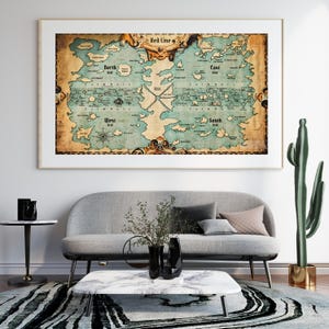 May include: A framed vintage-style map with a nautical theme, featuring landmasses in shades of blue and brown. The map is labeled with compass directions and the text "Red Line". The map is displayed above a gray sofa.