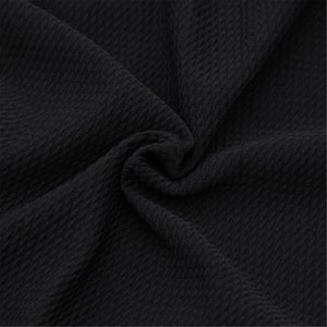 May include: Black textured fabric with a soft, slightly rippled surface.