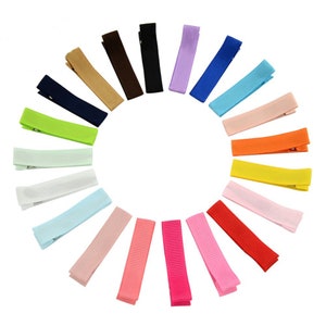 May include: A set of 20 hair clips in various colors, including pink, red, orange, yellow, green, blue, purple, brown, and white. The clips are made of ribbon and have a metal clip on the back.