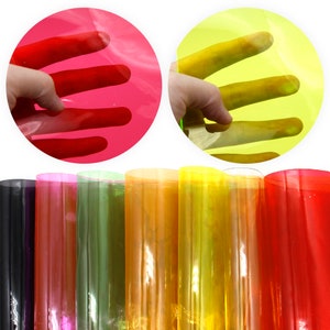 May include: Assortment of ten translucent colored sheets of plastic in various colors including black, pink, green, orange, yellow, and red.