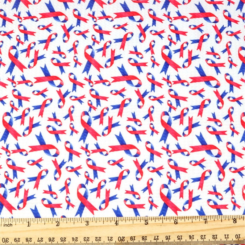 May include: White fabric with a repeating pattern of red and blue ribbon designs. The ribbons are arranged in a random pattern and are all facing the same direction.