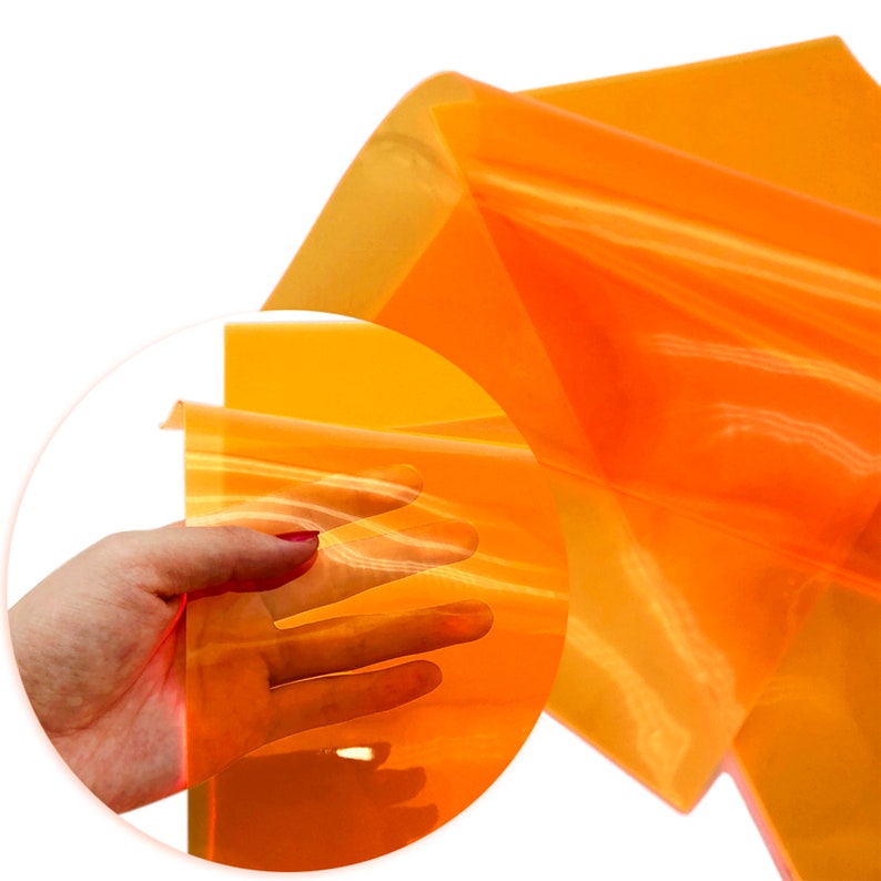 May include: A sheet of translucent orange craft vinyl. The vinyl is flexible and has a slight sheen.