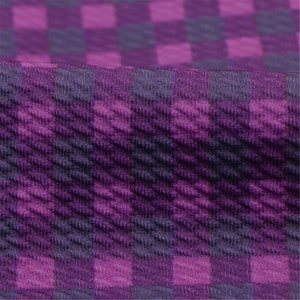 May include: Purple and dark purple checkered fabric with a textured surface.