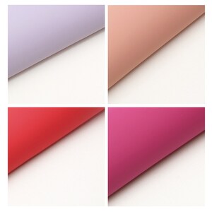 May include: Four sheets of colored tissue paper, each folded in half. The colors are lavender, peach, red, and pink.