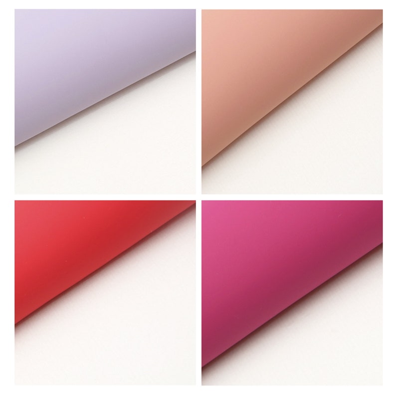 May include: Four sheets of colored tissue paper, each folded in half. The colors are lavender, peach, red, and pink.
