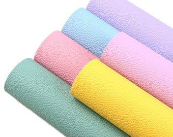 May include: Five rolls of faux leather in different pastel colors: light green, yellow, pink, light blue, and lavender. The faux leather has a textured surface.