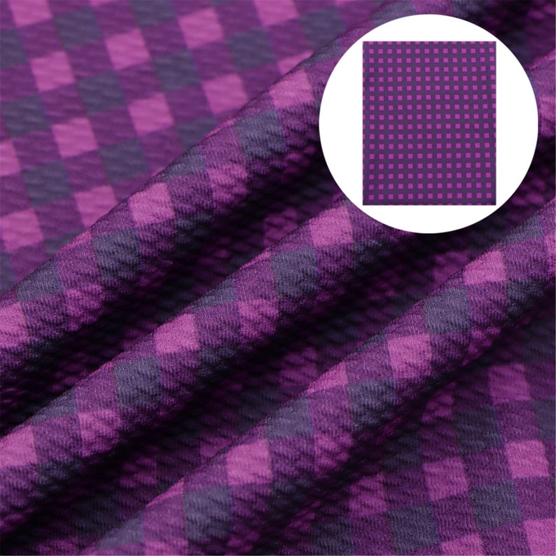 May include: Purple and dark purple checkered fabric with a textured surface.