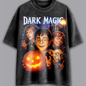 May include: Dark gray t-shirt featuring a graphic of characters from a fantasy movie, including a glowing jack-o'-lantern. The text "DARK MAGIC" is printed across the top. The shirt has a vintage, distressed look.
