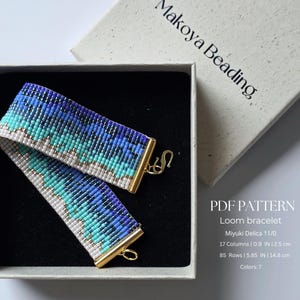 May include: A woven loom bracelet featuring a gradient pattern of blue, turquoise, and white beads. The bracelet has gold-tone metal end bars and a hook clasp. Text on the box reads Makoya Beading, PDF PATTERN, Loom bracelet, Miyuki Delica 11/0, 17 Columns | 0.9 IN, 85 Rows | 5.85 IN, Colors: 7.