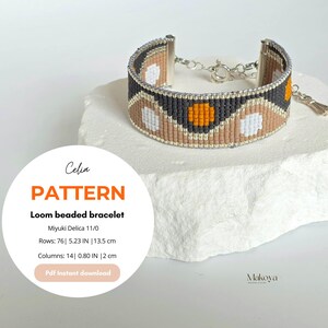 May include: A loom beaded bracelet with a geometric pattern in black, tan, white, and orange. The bracelet is 5.23 inches (13.5 cm) long and features a silver clasp. The image also includes a pattern design with text that reads "Celia Pattern Loom beaded bracelet".
