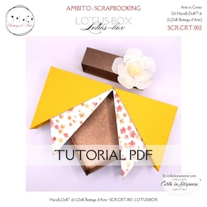 Può includere: Un progetto di scrapbooking in carta gialla e fantasia floreale con il testo "TUTORIAL PDF". Il progetto è una scatola con coperchio marrone e un fiore bianco. È visibile anche il testo "LOTUS-BOX".