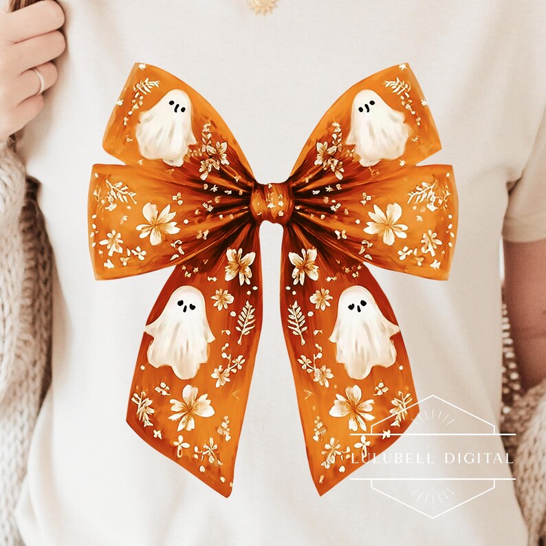 An oversized orange ribbon bow features soft painted brushstrokes, delicate white flowers, and four cute little white ghosts with smiling faces. The bow has a whimsical coquette style, perfect for Halloween crafts, soft spooky designs, or autumn-themed decor.