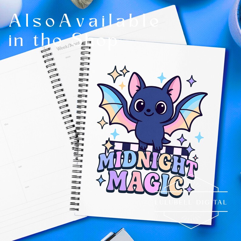 May include: A spiral-bound notebook with a cartoon bat illustration. The bat is dark blue with pastel wings and is perched above the words "MIDNIGHT MAGIC". The notebook is white with a blue background and the text "Also Available in the Shop".