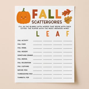 May include: A white paper game sheet titled FALL SCATTERGORIES with a cartoon pumpkin and autumn leaves. The text reads: FILL IN THE BLANKS WITH WORDS THAT BEGIN WITH EACH LETTER. THE PLAYER WITH THE MOST ANSWERS WINS! The letters L E A F are listed.
