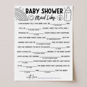May include: A white Baby Shower Mad Libs game card with black text, a rainbow, stars, a baby bottle, and a smiling face. The card includes fill-in-the-blank prompts for guests to complete.