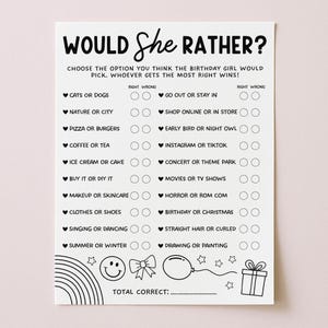 May include: A white paper game sheet with the text "WOULD She RATHER?" in black. The game includes multiple choice questions such as "Cats or Dogs" and "Pizza or Burgers". Decorative elements include a rainbow, stars, and a gift.