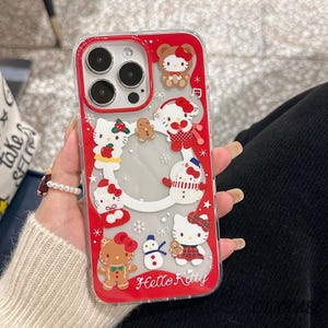 May include: Clear phone case with a red border featuring Hello Kitty and holiday-themed designs. The case includes images of Hello Kitty dressed as a snowman, gingerbread, and other festive characters. The words "Hello Kitty" are printed at the bottom.
