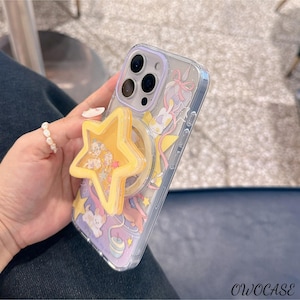 May include: Transparent phone case with a cartoon design and a yellow star-shaped phone grip. The case features a purple and yellow background with cartoon characters and the text "OWOCASE" at the bottom.