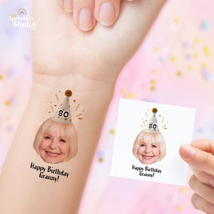 May include: Temporary tattoo showing an elderly woman wearing a party hat with the number 80. The tattoo reads "Happy Birthday Granny!" in black script. A second tattoo is shown on a white square.