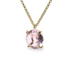 May include: A delicate gold chain necklace with a pale pink oval gemstone pendant.