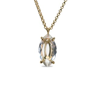 May include: A gold chain necklace with a clear marquise-shaped crystal pendant.