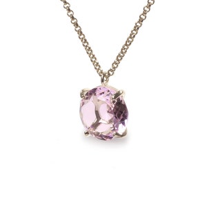 May include: A delicate gold chain necklace with a light pink gemstone pendant.